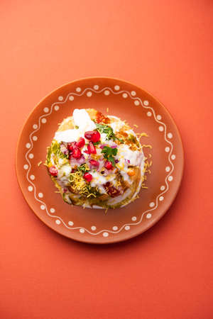 Rajasthani Shahi Raj Kachori, stuffed with potato and sprout filling. served with curd, chutney and sev in a plateの写真素材