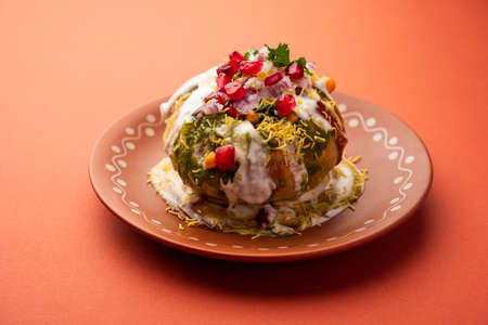 Rajasthani Shahi Raj Kachori, stuffed with potato and sprout filling. served with curd, chutney and sev in a plateの写真素材