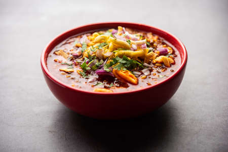 Misal pav is a popular Maharashtrian street food of usal, sprouts curry, topped with onions,...