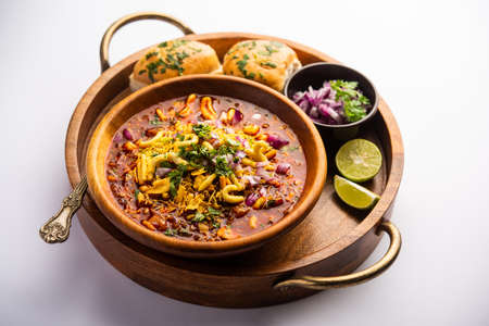 Misal pav is a popular Maharashtrian street food of usal, sprouts curry, topped with onions,...
