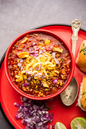 Misal pav is a popular Maharashtrian street food of usal, sprouts curry, topped with onions,...