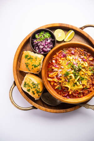 Misal pav is a popular Maharashtrian street food of usal, sprouts curry, topped with onions, tomatoes, farsan and chutneyの写真素材
