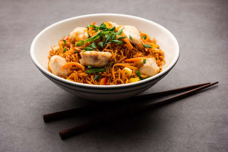 Chicken Fried rice is a popular Indian chinese or indo-chinese street food served in a plate with chopsticksの写真素材