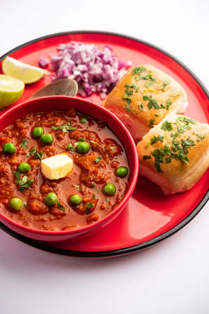 Pav bhaji is a fast food dish from India consisting of a thick vegetable curry served with a soft bread rollの写真素材