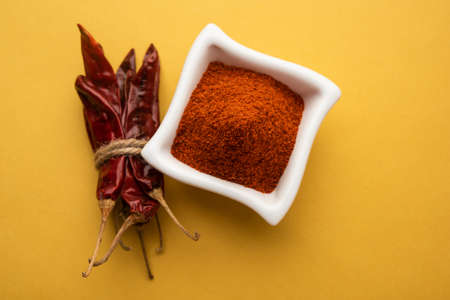 Red Chilli or Lal Mirchi or mirch with Powder in a bowl or mortar over moody background, selective focusの写真素材