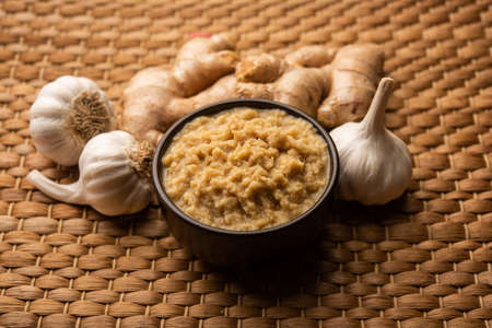 Fresh Ginger and Garlic paste or Adrak Lahsun puree in a ceramic bowl. Selective focusの写真素材