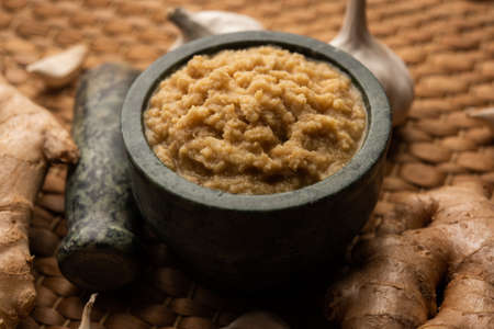 Fresh Ginger and Garlic paste or Adrak Lahsun puree in a ceramic bowl. Selective focusの写真素材