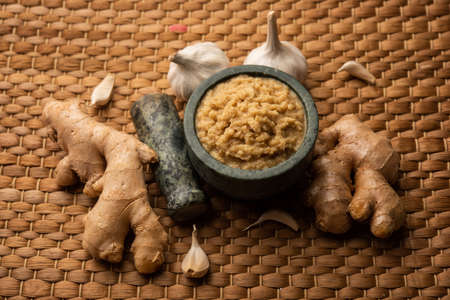 Fresh Ginger and Garlic paste or Adrak Lahsun puree in a ceramic bowl. Selective focusの写真素材