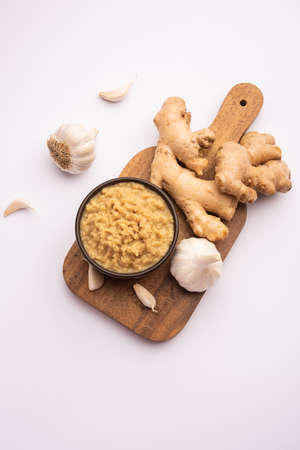 Fresh Ginger and Garlic paste or Adrak Lahsun puree in a ceramic bowl. Selective focusの写真素材