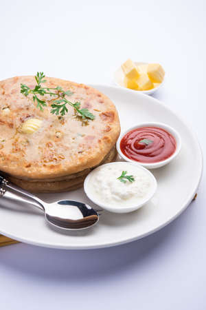 Aloo paratha or gobi paratha also known as Potato or Cauliflower stuffed flatbread dish originating...