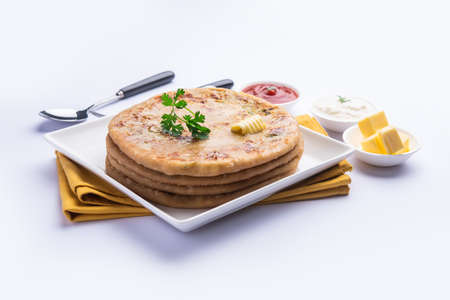 Aloo paratha or gobi paratha also known as Potato or Cauliflower stuffed flatbread dish originating...