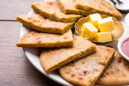 Aloo paratha or gobi paratha also known as Potato or Cauliflower stuffed flatbread dish originating...