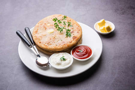 Aloo paratha or gobi paratha also known as Potato or Cauliflower stuffed flatbread dish originating...