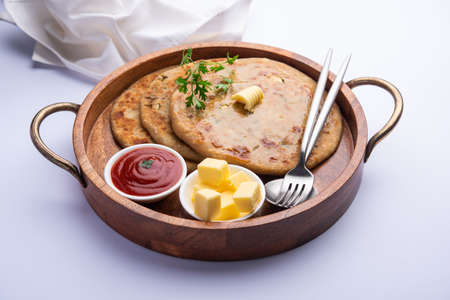 Aloo paratha or gobi paratha also known as Potato or Cauliflower stuffed flatbread dish originating...