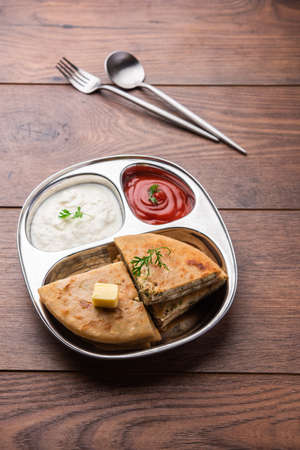 Aloo paratha or gobi paratha also known as Potato or Cauliflower stuffed flatbread dish originating...