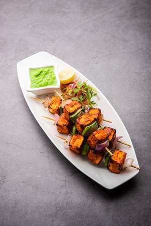 Paneer tikka is an Indian dish made from chunks of cottage cheese marinated in spices and grilled in a tandoorの写真素材
