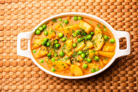 Aloo mutter is a Punjabi dish from the Indian subcontinent which is made from potatoes and peas in a spiced creamy tomato based sauceの写真素材