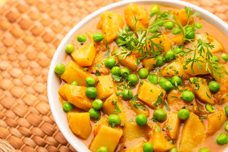 Aloo mutter is a Punjabi dish from the Indian subcontinent which is made from potatoes and peas in a spiced creamy tomato based sauceの写真素材