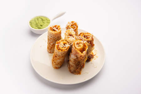 Gini or Jini Dosa is a mumbai style street food variety served in a plate with green chutneyの写真素材