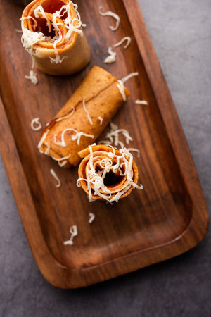 Gini or Jini Dosa is a mumbai style street food variety served in a plate with green chutneyの写真素材