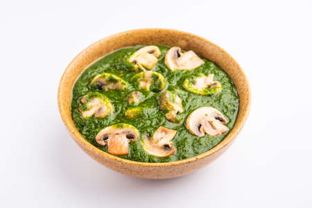 Palak Mushroom is a healthy and delicious dish of sauteed button mushrooms and aromatics in a creamy spinach sauceの写真素材