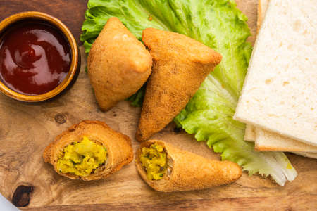 Bread samosa is a variation of regular samosa with same potato peas filling using sandwich bread...