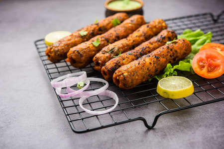 Seekh Kabab made with minced chicken or Mutton keema, served with green chutney and salad