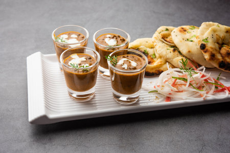 Dal Makhani or dal makhni Shots with Naan kidney beans, butter and cream and served with garlic naan...