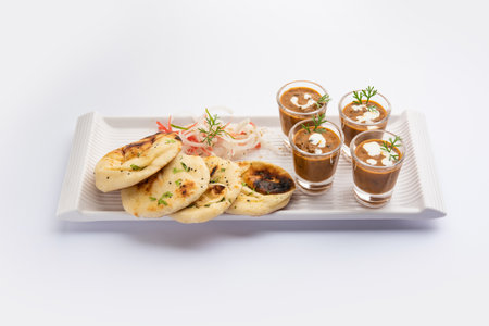Dal Makhani or dal makhni Shots with Naan kidney beans, butter and cream and served with garlic naan...