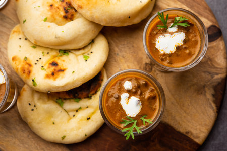 Dal Makhani or dal makhni Shots with Naan kidney beans, butter and cream and served with garlic naan or Indian bread or rotiの写真素材