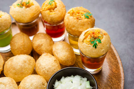 Panipuri shot or Golgappa Shots, different flavours of water served in small glasses with stuffed...