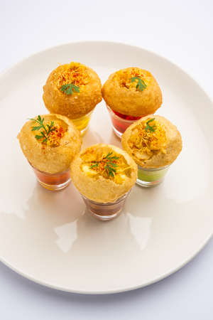Panipuri shot or Golgappa Shots, different flavours of water served in small glasses with stuffed...