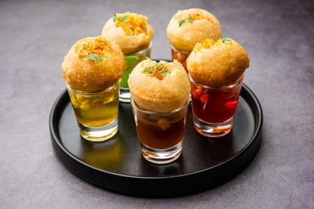 Panipuri shot or Golgappa Shots, different flavours of water served in small glasses with stuffed...