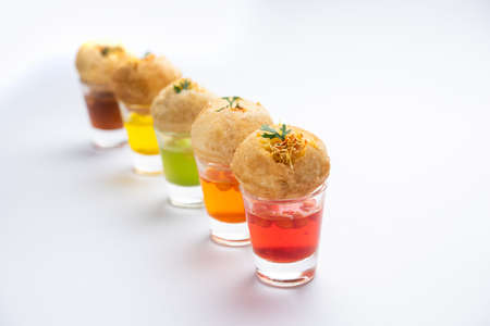 Panipuri shot or Golgappa Shots, different flavours of water served in small glasses with stuffed...