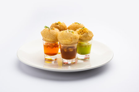 Panipuri shot or Golgappa Shots, different flavours of water served in small glasses with stuffed...