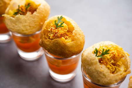 Panipuri shot or Golgappa Shots, different flavours of water served in small glasses with stuffed...