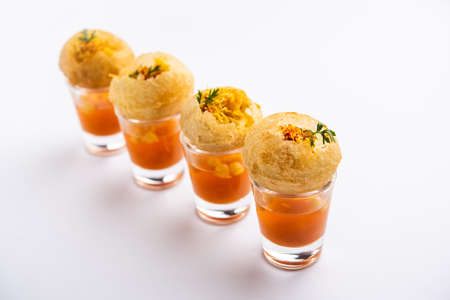 Panipuri shot or Golgappa Shots, different flavours of water served in small glasses with stuffed...