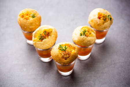 Panipuri shot or Golgappa Shots, different flavours of water served in small glasses with stuffed puri, Indian starter snackの写真素材