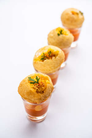 Panipuri shot or Golgappa Shots, different flavours of water served in small glasses with stuffed...