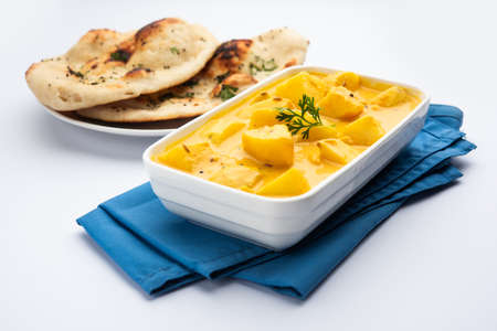 Dahi wale Aloo or AalooÂ orÂ yogurt or curd potato curry, an Indian Classical dish, served in bowl with naan. selective focusの写真素材