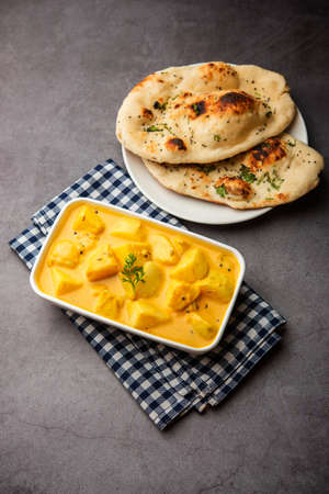 Dahi wale Aloo or AalooÂ orÂ yogurt or curd potato curry, an Indian Classical dish, served in bowl with naan. selective focusの写真素材