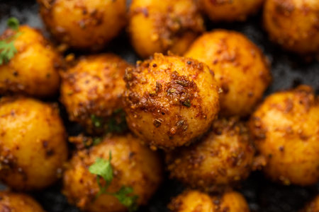 Homemade Roasted Bombay potatoes. Pan fried little baby potatoes or aloo with jeera seeds and coriander in bowlの写真素材
