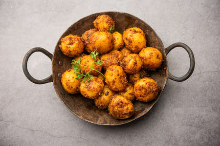Homemade Roasted Bombay potatoes. Pan fried little baby potatoes or aloo with jeera seeds and coriander in bowlの写真素材