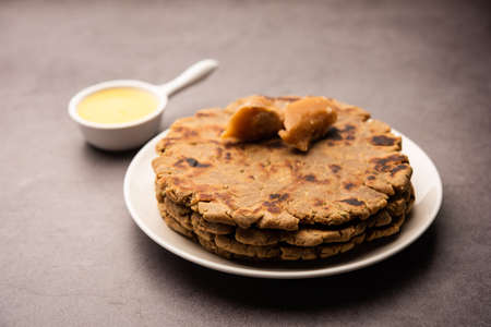 Sweet roti made out of rice flour, jaggery, and ghee. Gud ki roti. gur ki roti, jaggery Bhakri,...