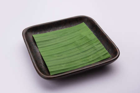 banana leaf on blank plate for edit food or subject onの写真素材