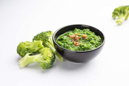 Fresh broccoli chutney or paste, puree in the bowl with raw piecesの写真素材
