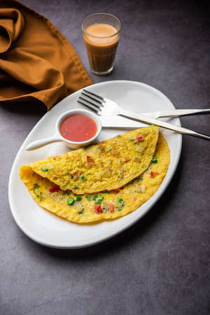 Indian Spiced Masala Omelet filled with fresh vegetable, healthy mealの写真素材