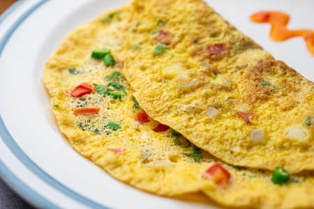 Indian Spiced Masala Omelet filled with fresh vegetable, healthy mealの写真素材
