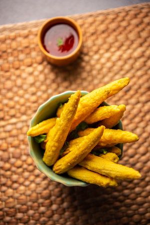 Crispy fried baby corn pakoda, pakora  or Baby corn fritters served with ketchup, Indian foodの写真素材