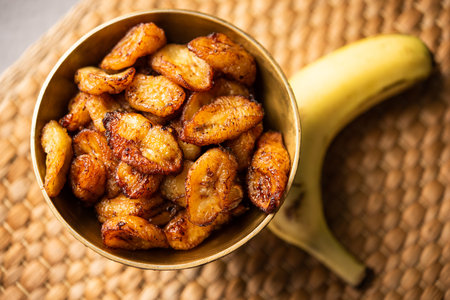 Deep fried ripe plantain slices or pake kele fried chips in a bowlの写真素材